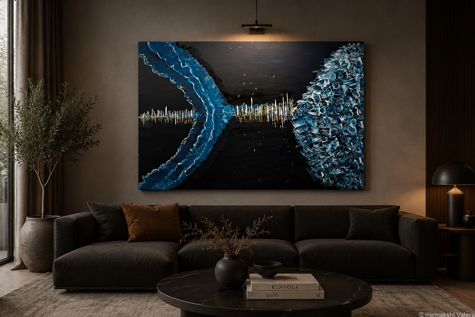 Where Winter Sings, a large original ice blue, black and gold abstract painting, hanging as a statement piece above a sofa