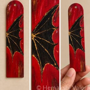 Crimson Wing red bookmark with a black dragon wing and gold painted details
